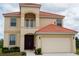 Two-story house with a two-car garage and terracotta roof at 573 Viola Dr, Davenport, FL 33837