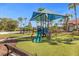 playground with slides, swings, and shaded area at 573 Viola Dr, Davenport, FL 33837