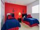 Nautical-themed bedroom with two twin beds and red accents at 573 Viola Dr, Davenport, FL 33837