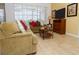 Comfortable living room with neutral colored furniture and tile floors at 573 Viola Dr, Davenport, FL 33837