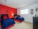 Nautical-themed bedroom with two twin beds and red accents at 573 Viola Dr, Davenport, FL 33837
