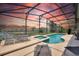 Relaxing screened-in pool and spa area with lounge chairs at 573 Viola Dr, Davenport, FL 33837