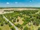 Aerial view of property with a pond and adjacent road at 1235 Hackney Rd, Saint Cloud, FL 34771