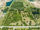 Aerial view highlighting a sizable lot bordered by a road and water features at 1235 Hackney Rd, St Cloud, FL 34771