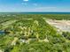 Aerial view of a lot near a body of water and surrounded by trees at 1235 Hackney Rd, Saint Cloud, FL 34771