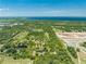 Aerial view of property with a pond and nearby lake. Surrounded by lush vegetation at 1235 Hackney Rd, St Cloud, FL 34771