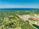 Aerial view of a lot with lush vegetation, a pond, and nearby lake at 1235 Hackney Rd, St Cloud, FL 34771