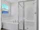 Bathroom with soaking tub, walk-in shower, and tile flooring at 4248 Sawtooth Ct, Tavares, FL 32778