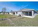 Rear view of house with covered patio and landscaping at 4248 Sawtooth Ct, Tavares, FL 32778
