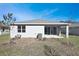 Rear view of the house with sliding glass doors at 4248 Sawtooth Ct, Tavares, FL 32778