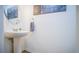 Small bathroom with pedestal sink and decorative wall art at 350 Madison Dr, Davenport, FL 33837