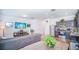 Living room with sectional sofa, TV, and kitchen view at 350 Madison Dr, Davenport, FL 33837