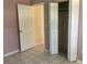 Bedroom with tiled floors, closet, and door to another room at 101 Albert St, Winter Springs, FL 32708