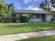 Gray house with a spacious yard and mature landscaping at 101 Albert St, Winter Springs, FL 32708