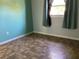 Simple bedroom with teal walls and tile flooring at 101 Albert St, Winter Springs, FL 32708