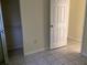 Bedroom featuring tiled floors, closet, and access to hallway at 101 Albert St, Winter Springs, FL 32708