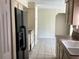 View of kitchen with black refrigerator and white sink at 101 Albert St, Winter Springs, FL 32708