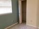 Small bedroom with tiled floor, window with blinds, and closet at 101 Albert St, Winter Springs, FL 32708