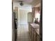 Kitchen with double sink, black refrigerator, and beige cabinets at 101 Albert St, Winter Springs, FL 32708