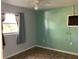 Bedroom with teal walls, tile floor, and window at 101 Albert St, Winter Springs, FL 32708