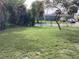 Large backyard with lush grass and mature trees at 101 Albert St, Winter Springs, FL 32708