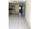Kitchen with tiled floor, appliances, and access to hallway at 101 Albert St, Winter Springs, FL 32708