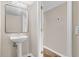 Small bathroom with pedestal sink and mirror at 1003 Dampierre Ct, Kissimmee, FL 34759