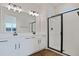 Bathroom with white vanity, black hardware, and frameless shower at 6333 Clover St, Lake Hamilton, FL 33851