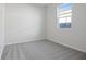 Simple bedroom with gray carpet and neutral walls at 6333 Clover St, Lake Hamilton, FL 33851