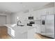 Modern kitchen with white cabinets, stainless steel appliances, and large island at 6333 Clover St, Lake Hamilton, FL 33851