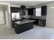 Open kitchen features dark cabinetry, granite countertops, and stainless steel appliances at 2757 Creekmore Ct, Kissimmee, FL 34746