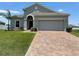 Single-story house with a two-car garage and a paved driveway at 2757 Creekmore Ct, Kissimmee, FL 34746