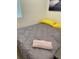 Cozy bedroom with gray bedding and yellow pillows at 793 Benoi Dr, Davenport, FL 33896