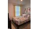 Bright bedroom with yellow curtains and patterned bedding at 793 Benoi Dr, Davenport, FL 33896