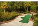 Landscaped mini golf course with paved pathway at 793 Benoi Dr, Davenport, FL 33896