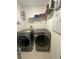 Spacious laundry room with washer, dryer, and shelving at 793 Benoi Dr, Davenport, FL 33896