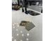 Modern kitchen features a large island with double sinks and quartz countertops at 793 Benoi Dr, Davenport, FL 33896
