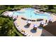 Resort-style pool with plenty of lounge chairs and umbrellas at 6333 Clover St, Lake Hamilton, FL 33851