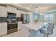 Modern kitchen with stainless steel appliances and breakfast bar at 3121 Paradox Circle 207 # 207, Kissimmee, FL 34746