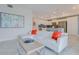 Bright living room features a white sectional sofa, large TV, and a modern coffee table at 3121 Paradox Circle 207 # 207, Kissimmee, FL 34746
