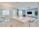 Open concept kitchen with island and breakfast bar, modern white cabinets, and stainless steel appliances at 3121 Paradox Circle 207 # 207, Kissimmee, FL 34746