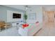 Bright living room with white sofa, large TV, and access to balcony at 3121 Paradox Circle 207 # 207, Kissimmee, FL 34746