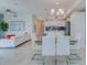 Open concept dining area with glass table and kitchen access at 3121 Paradox Circle 207 # 207, Kissimmee, FL 34746