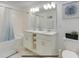 Clean bathroom with double vanity, large mirror, and bathtub at 3191 Paradox Cir # 205, Kissimmee, FL 34746