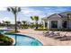 Relaxing pool area with lounge chairs and a clubhouse nearby at 3191 Paradox Cir # 205, Kissimmee, FL 34746