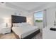 Main bedroom with plush bed, tufted headboard, and nightstands at 3191 Paradox Cir # 205, Kissimmee, FL 34746