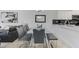 Modern dining room with glass table, grey chairs and bench at 3191 Paradox Cir # 205, Kissimmee, FL 34746