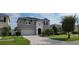 Two-story house with attached garage and landscaping at 2391 Beacon Park Landing Cir, Orlando, FL 32824
