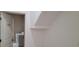 Convenient laundry room with washer, dryer, and shelving at 2391 Beacon Park Landing Cir, Orlando, FL 32824