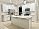 Modern kitchen with white cabinets, island, and stainless steel appliances at 2391 Beacon Park Landing Cir, Orlando, FL 32824